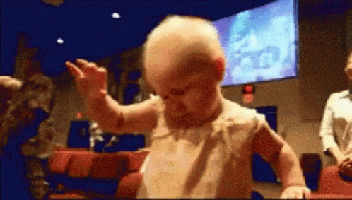A Baby Is Dancing In Front Of A Screen That Says 2:40 GIF