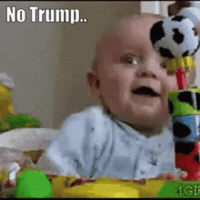 A Baby Is Holding A Stuffed Soccer Ball On Top Of A Stack Of Blocks With The Caption " No Trump " Above It GIF