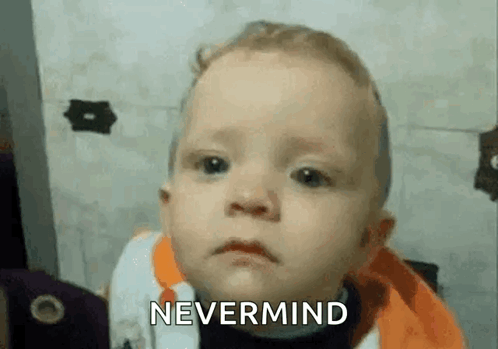 A Baby Is Making A Funny Face And Says `` Nevermind '' . GIF