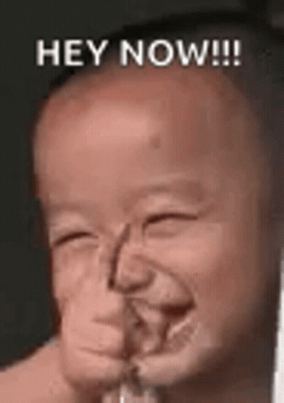A Baby Is Making A Funny Face And Smiling With The Words `` Hey Now '' . GIF