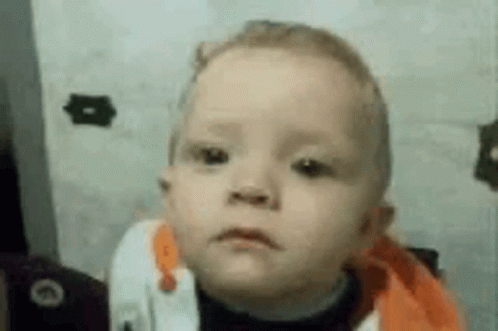 A Baby Is Making A Funny Face In A Close Up Of His Face . GIF