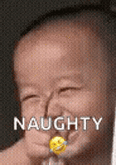 A Baby Is Making A Funny Face With A Smiley Face In His Mouth . GIF