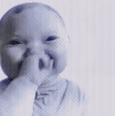A Baby Is Making A Funny Face With His Finger In His Mouth GIF