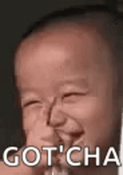 A Baby Is Making A Funny Face With The Words `` Gotcha '' Written Above It . GIF