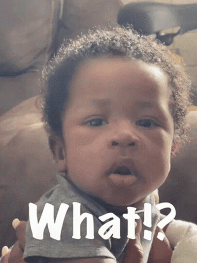 A Baby Is Making A Funny Face With The Words What Written Above Him GIF