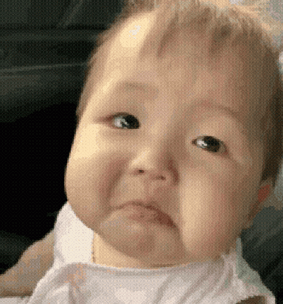 A Baby Is Making A Sad Face And Making A Funny Face . GIF