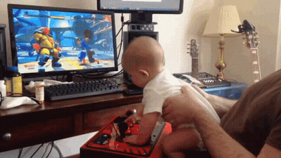 A Baby Is Playing A Video Game On A Dell Computer GIF