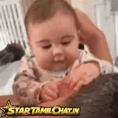 A Baby Is Playing With A Star Tamilchat.in Logo On The Bottom GIF
