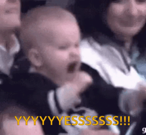 A Baby Is Screaming In A Crowd With The Words " Yyyyyssssss " In Yellow GIF