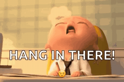 A Baby Is Sitting At A Desk With A Pen In His Hand And The Words `` Hang In There '' . GIF