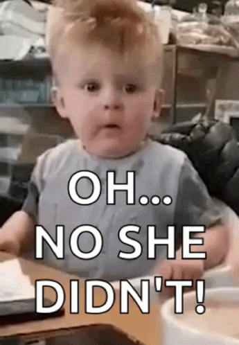 A Baby Is Sitting At A Table And Making A Funny Face And Saying `` Oh ... No She Didn 'T ! '' GIF