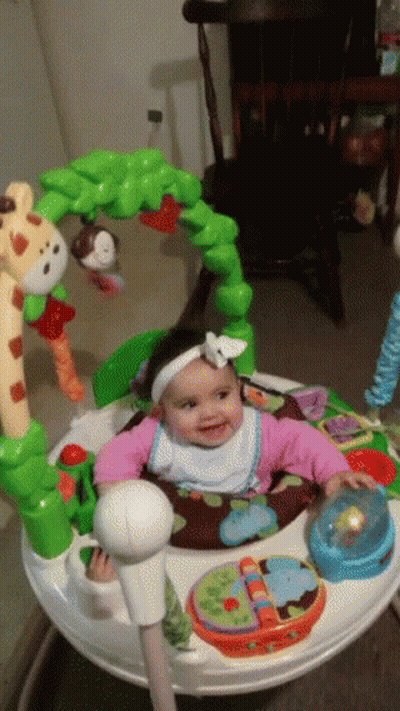 A Baby Is Sitting In A Bouncer With A Giraffe And Monkey On It GIF