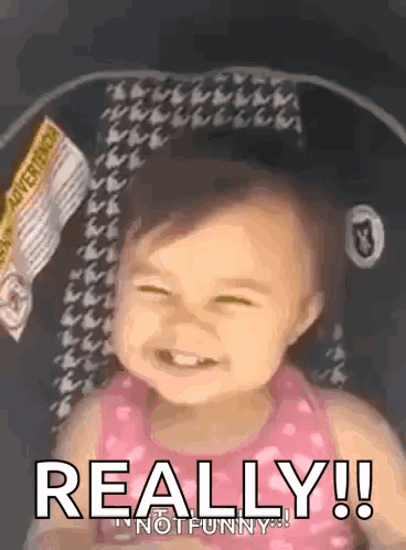 A Baby Is Sitting In A Car Seat And Smiling With The Words Really ! Not Funny . GIF