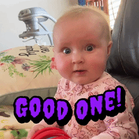 A Baby Is Sitting In A Chair With A Good One Sticker On His Face GIF