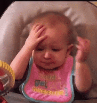 A Baby Is Sitting In A High Chair Holding Her Head . GIF