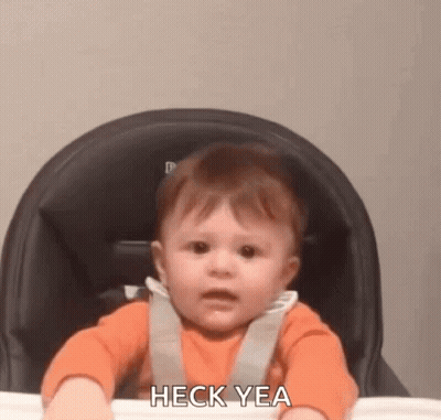 A Baby Is Sitting In A High Chair Making A Funny Face And Saying Heck Yea . GIF