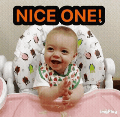 A Baby Is Sitting In A High Chair Smiling And Clapping . GIF