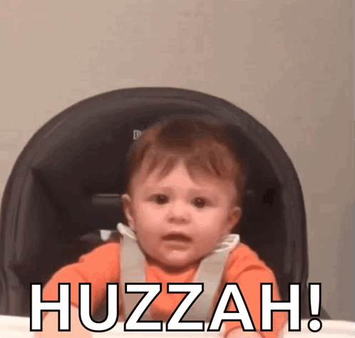 A Baby Is Sitting In A High Chair With The Words Huzzah Written On The Bottom GIF