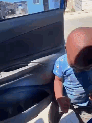 Baby Sitting In Car Back Seat Wearing Mask GIF
