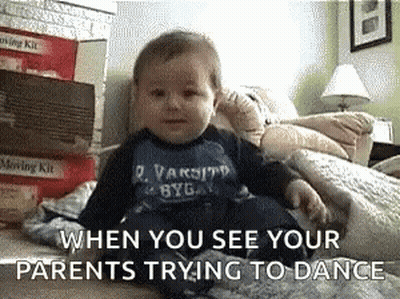 A Baby Is Sitting On A Bed With The Words " When You See Your Parents Trying To Dance " Above Him GIF