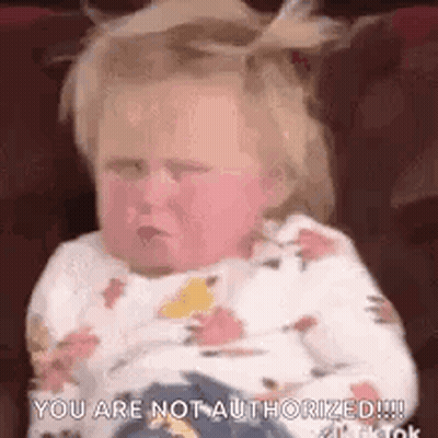 A Baby Is Sitting On A Couch And Making A Face . GIF