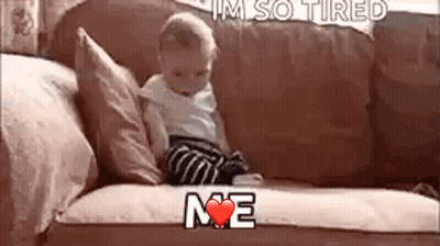 A Baby Is Sitting On A Couch With The Words `` I 'M So Tired Me '' Written On It . GIF
