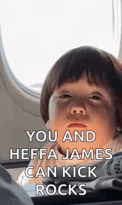 A Baby Is Sitting On An Airplane With A Black Eye And A Funny Face . GIF