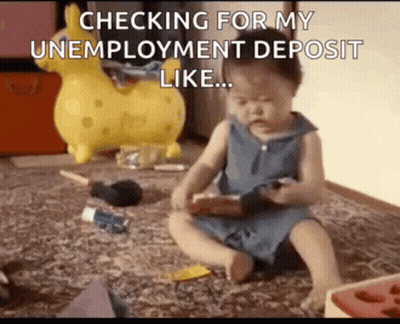 A Baby Is Sitting On The Floor Playing With A Toy And A Phone . GIF
