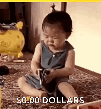 A Baby Is Sitting On The Floor Playing With A Toy And Holding A Cell Phone . GIF