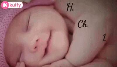 A Baby Is Sleeping On A Pink Pillow With The Words Happy Childr Dr. Written On It . GIF
