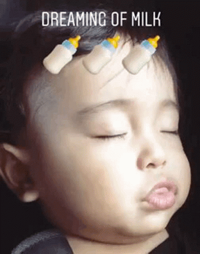 A Baby Is Sleeping With Bottles On His Head And The Words Dreaming Of Milk Above Him . GIF
