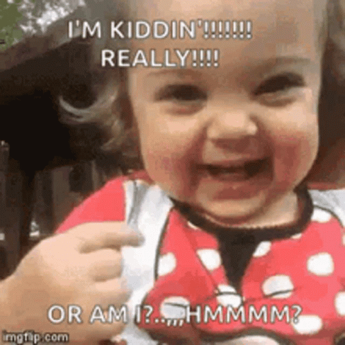A Baby Is Smiling And Pointing At The Camera . GIF