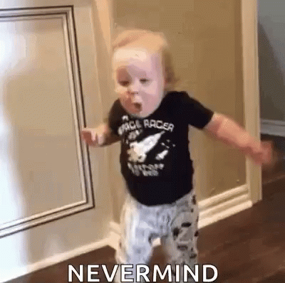 A Baby Is Standing In A Hallway With The Words `` Nevermind '' Written On The Bottom . GIF
