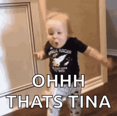A Baby Is Standing In A Hallway With The Words Ohhh Thats Tina Written On The Wall . GIF