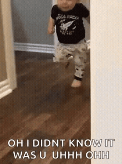 A Baby Is Walking Through A Doorway And Says `` Oh I Didnt Know It Was U Uhh Ohh '' . GIF