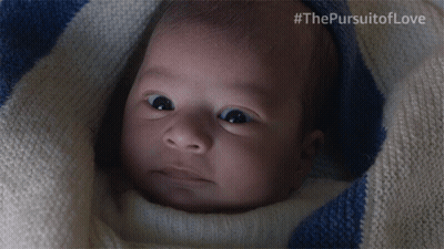 A Baby Is Wrapped In A Blue And White Striped Blanket With #Thepursuitoflove Written On The Bottom GIF