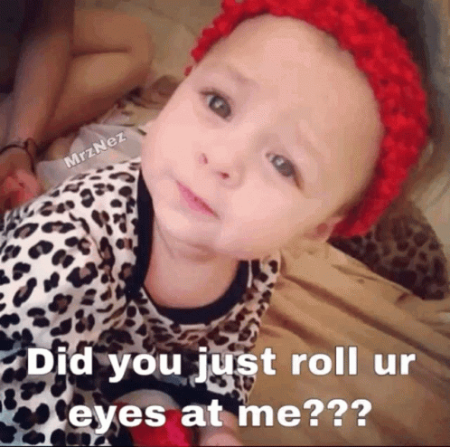 A Baby Laying On A Bed With A Caption That Says Did You Just Roll Ur Eyes At Me?? GIF