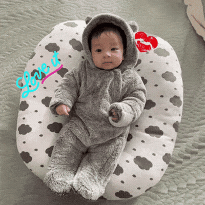 A Baby Laying On A Pillow That Says Love It On It GIF