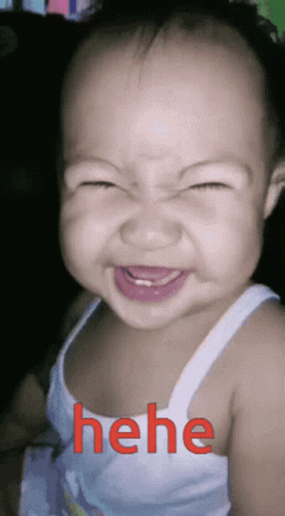 A Baby Making A Funny Face With The Word " Hehe " In Red Behind Him GIF