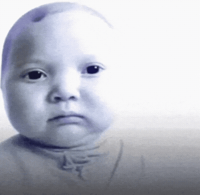 A Baby 'S Face Is Shown With A Serious Look On His Face GIF