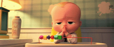 A Baby Sitting In A High Chair With A Bottle Of Baby Powder Behind Him GIF
