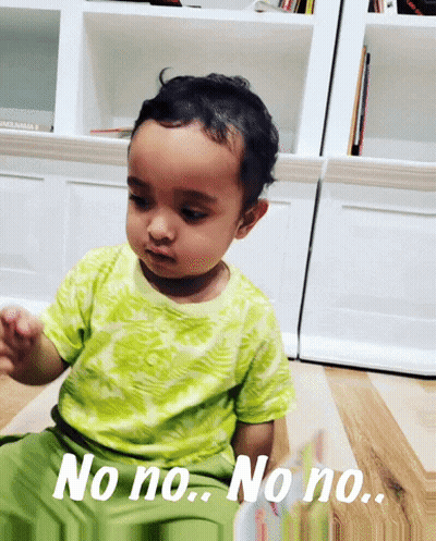 A Baby Sitting On The Floor With The Words No No No No GIF