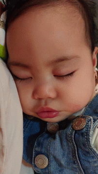 A Baby Wearing A Denim Jacket With The Letter O On The Buttons GIF