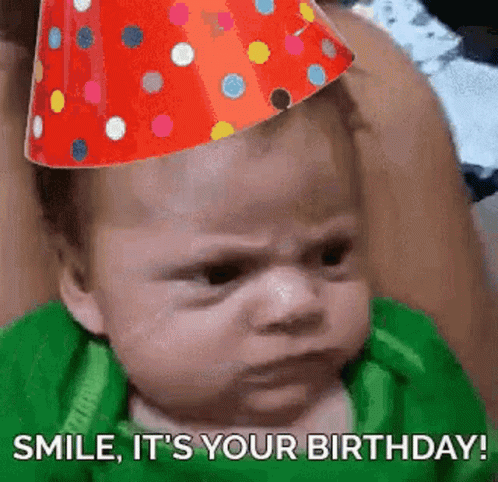 A Baby Wearing A Party Hat Is Making A Funny Face And Says `` Smile , It 'S Your Birthday ! '' GIF