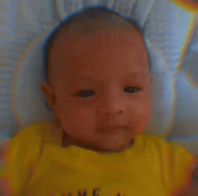 A Baby Wearing A Yellow Shirt That Says Love GIF