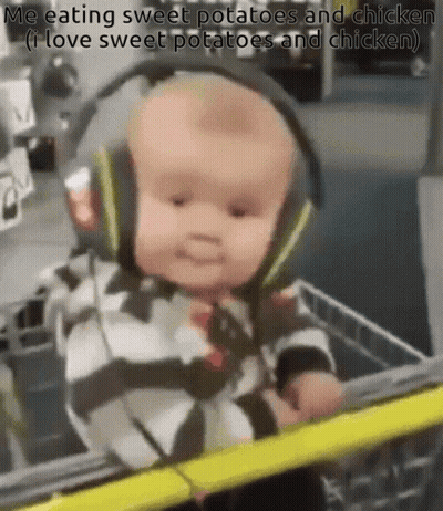 A Baby Wearing Headphones Is Sitting In A Shopping Cart And Eating Sweet Potatoes And Chicken . GIF