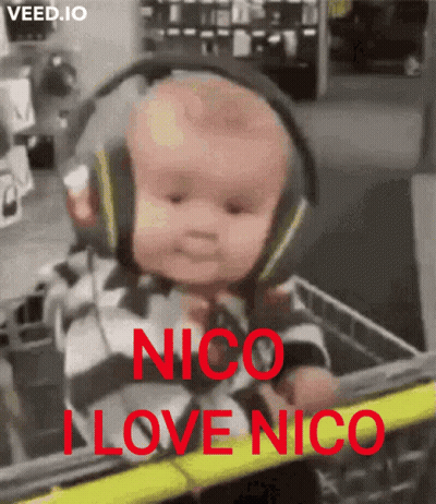 A Baby Wearing Headphones Is Sitting In A Shopping Cart With The Words " Nico I Love Nico " On It GIF