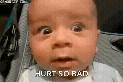 A Baby With A Surprised Look On His Face Is Sitting In A Stroller . GIF