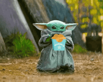 A Baby Yoda Is Holding A Box Of Nuggets In His Hand . GIF