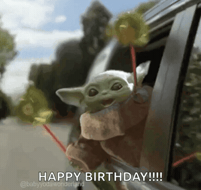 A Baby Yoda Is Sticking Its Head Out Of A Car Window While Holding Lollipops . GIF
